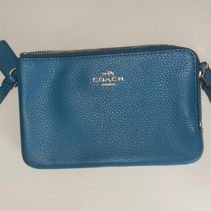 Turquoise coach wristlet.